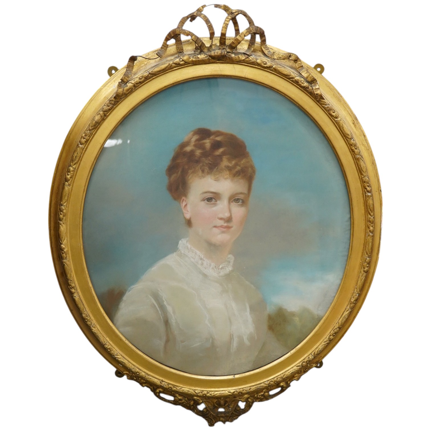 Early 20th century English School, oval pastel, Portrait of a young woman, 61 x 56cm, housed in gilt gesso frame. Condition - fair, some damage to the frame